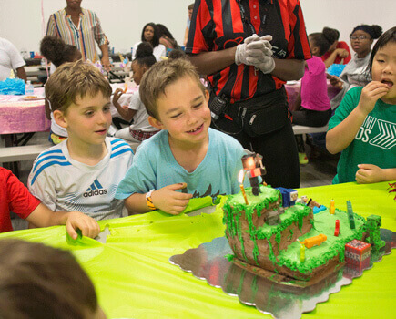 birthday boy enjoying his cake during his birthday party at Cosmic Air Trampoline Park in Katy TX