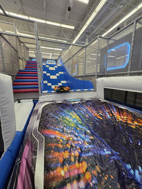 Glider Tube Slide at Cosmic Air in Webster, TX, indoor fun park.