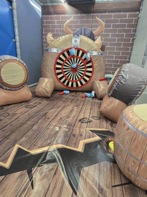 Kids Axe Throwing at Cosmic Air indoor park in Webster, Texas.